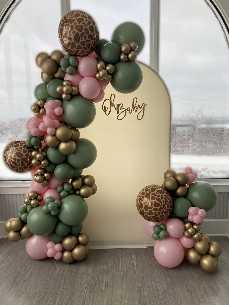 Sage, blush, and chrome gold organic balloon garland framing an Oh Baby neon backdrop with safari accents
